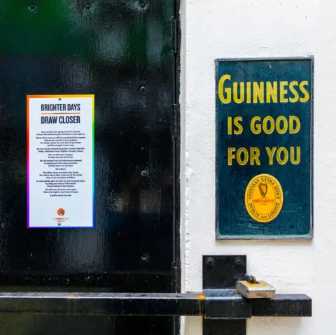 Colin Blackstock An image of a closed door next to a Guinness sign