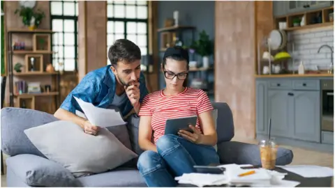 Getty Images Couple looking a bill
