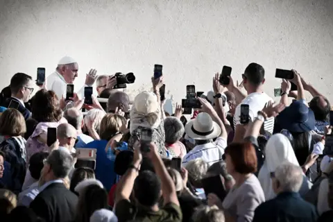Tiziana Fabi / AFP Pope Francis arrives to lead his weekly general audience at St Peter's Square in Vatican City