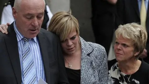 AFP/Getty Milly Dowler's 's father Bob, sister Gemma and mother Sally