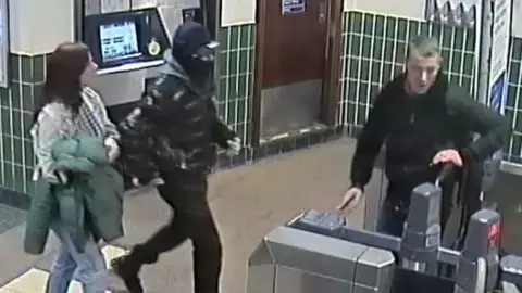 British Transport Police CCTV image of two men and a woman police would like to speak to in connection with the attack