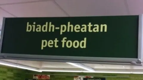 JONATHAN FORD 'Biadh' means food in Scottish Gaelic and 'pheatan' could be an attempt to translate 'peata,' meaning pet - the sign should read 'bwyd anifeiliaid anwes' in Welsh