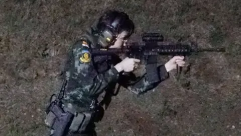 AFP Sineenat Wongvajirapakdi aims a weapon at a firing range