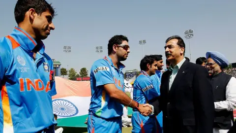 Getty Images Prime Minister Syed Yusuf Raza Gilani of Pakistan shakes hands with Yuvraj Singh of India as Prime Minister Manmohan Singh of India looks on prior to the start of the 2011 ICC World Cup