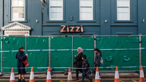 Getty Images People walk past a Zizzi restaurant which has been closed as investigations continue into the poisoning of Sergei Skripal