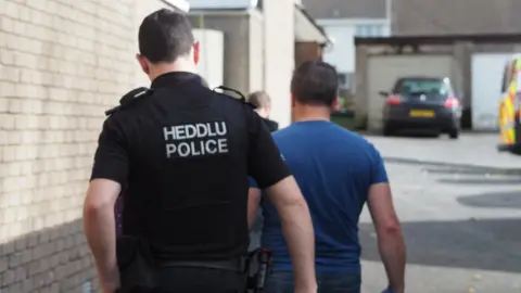 Dyfed Powys Police Police officers arresting someone