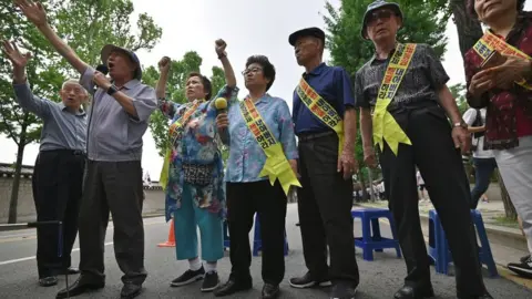 Getty Images Family members of South Korean victims of forced labour by Japan during World War Two, participate in a rally urging resolution of compensation in Seoul on 16 July