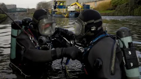 Getty Images Divers searching for missing person