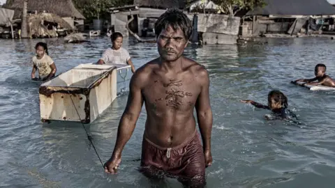 Getty Images Villagers in Kiribati affected by flooding