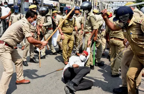 Getty Images Police in Uttar Pradesh attack an opposition activist protesting against the Hathras rape case