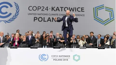 AFP COP24 President Michal Kurtyka celebrates at the end of the COP24 UN Climate Change Conference 2018 in Katowice, Poland