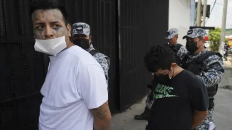 Getty Images A suspect is led into a detention centre on April 25, 2022 in San Salvador, El Salvador.