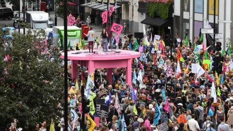 EPA large pink table surrounded by crowds