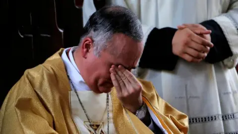 INTI OCON via Getty The Auxiliary Bishop of the Archdiocese of Managua, Silvio Jose Baez Ortega, cries during an Easter mass, his last mass at the Santo Cristo de Esquipulas Church in Managua on April 21, 2019.