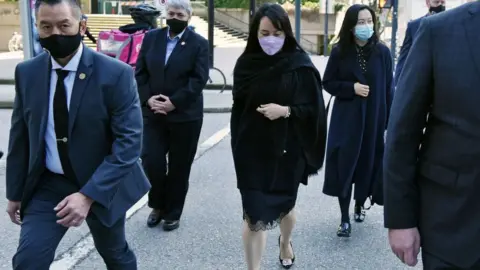 Getty Images Huawei Chief Financial Officer, Meng Wanzhou (C) leaves the British Columbia Supreme Court with her security detail in Vancouver, British Colombia on March 22, 2021.