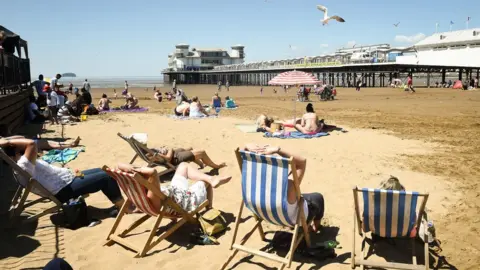 PA The beach scene in Weston with the Grand Pier in the background
