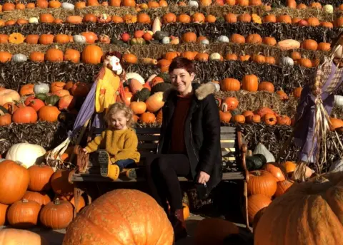 Paul Jones Sally and Ella Jones surrounded by pumpkins