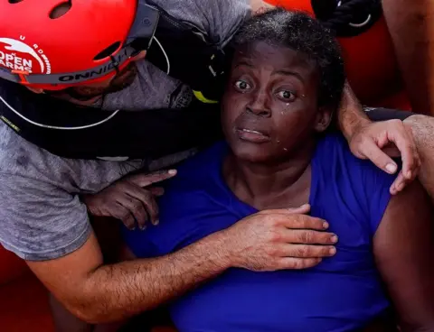 Reuters A crew member of NGO Proactiva Open Arms rescue boat embraces Josepha from Cameroon in central Mediterranean Sea