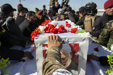 Getty Images The funeral of an Iraqi paramilitary chief and friend of Soleimani also killed in the US drone strike
