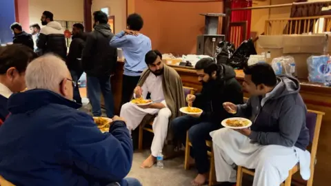 BBC A photo of people eating