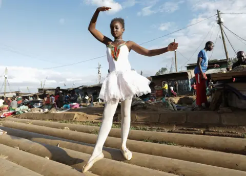 EPA A young ballerina poses for a photo during a ballet street performance to showcase their skills in Kibera slum, Nairobi, Kenya - Saturday 30 November 2018