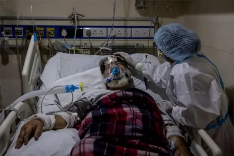 Reuters A medical worker tends to a patient suffering from the coronavirus disease (COVID-19), inside the ICU ward at Holy Family Hospital in New Delhi, India, April 29, 2021