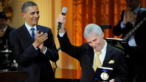 Reuters Burt Bacharach (R) reacts to applause after receiving the 2012 Library of Congress Gershwin Prize for Popular Song from U.S. President Barack Obama (L) during a concert in the East Room of the White House honoring Bacharach and his songwriting partner Hal David, in Washington, May 9, 2012