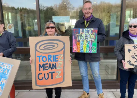 Shuan Whitmore/BBC Protesters to the scrapping of the scheme outside County Hall in Norwich