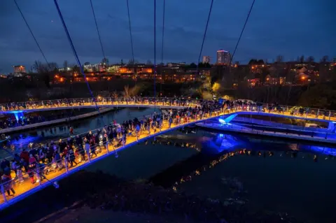 Pedestrian bridge opens with a celebration of light