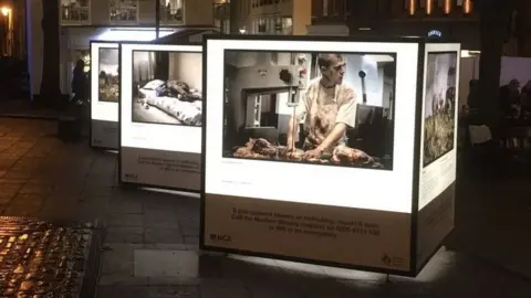 Rory Carnegie Photographs that depict modern slavery mounted on a cube