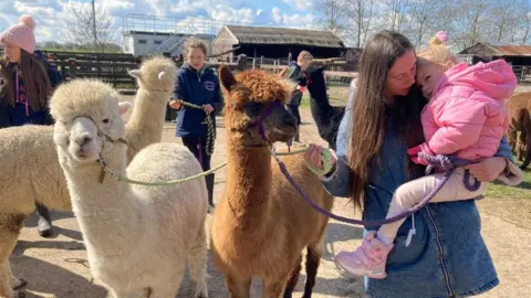 Jenny Kirk/BBC Masha and her daughter Lisa with alpacas