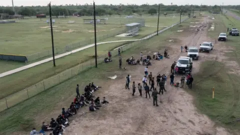 Reuters Asylum seeking unaccompanied minors from Central America are seen on the left in this aerial image after crossing the Rio Grande river into the United States from Mexico in La Joya, Texas, U.S., May 14, 2021