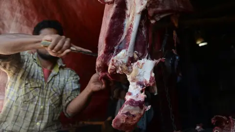 An Indian butcher cuts beef in his shop in Srinagar on September 10, 2015.