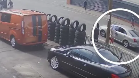 CCTV of tyre shop before shooting