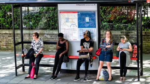 Getty Images Group of people at a bus stop