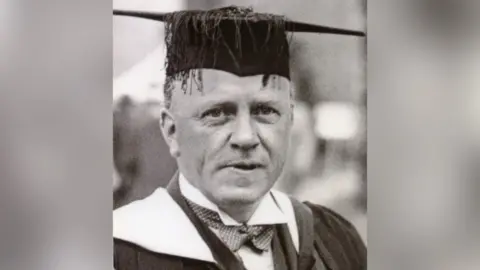 University of Leicester A black and white photo of Sir David Attenborough's father, Frederick Attenborough. He is wearing a mortarboard cap and a gown.