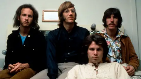 Photo of US rock group The Doors. Shows four men in late '60s/early '70s' garb, all sporting long hair.