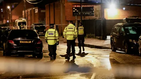 REUTERS/Temilade Adelaja Police officers walk on a street with a cordon in place