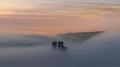 MONDAY - A misty sunrise at Corfe Castle  