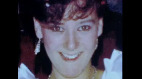 Family handout Julie Hogg, a young woman with brown hair smiles at the camera.