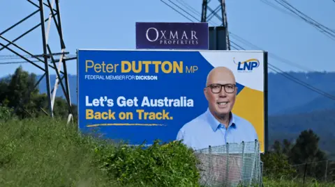An election advertising board for the LNP and Peter Dutton is seen next to power lines on April 23, 2025 in Strathpine, Brisbane.