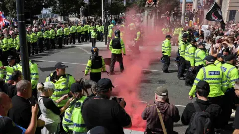 PA Police officers and demonstrators face-off in Liverpool.