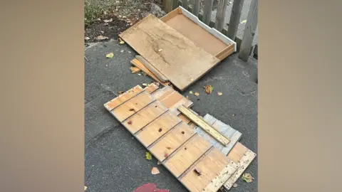 Bomere Heath CE Primary School A large wooden box broken open in a playground.