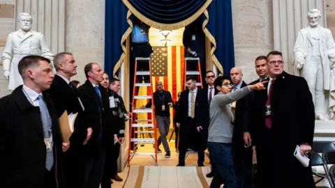 Getty Images Staff inside US Capitol building line up to set up inauguration ceremony