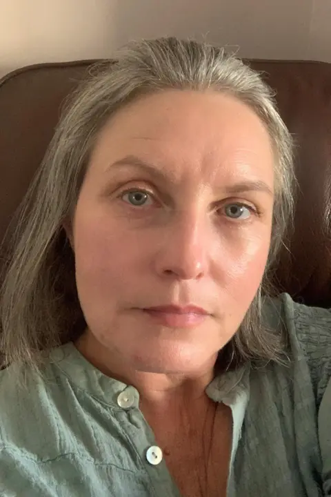 Clare Rees Clare Rees is looking at the camera in a close up photo in a green/grey top. She has shoulder length grey hair and blue eyes.