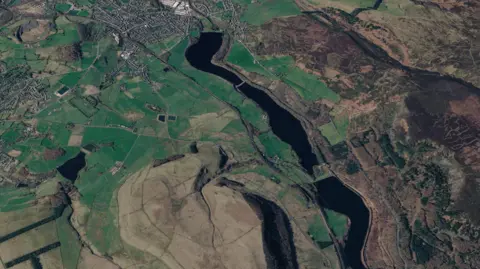A satellite image of the area near Glossop, with rugged terrain and waterways visible