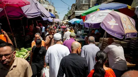 Getty Images A crowded market in Nablus as people prepare to celebrate the Eid al-Adha.