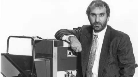 Alan Yentob pictured with a video camera in 1993