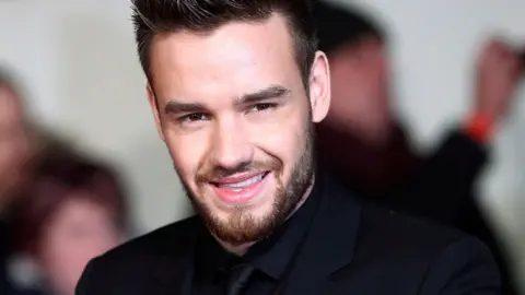 Reuters Liam Payne, dressed in black, smiling at a film premiere