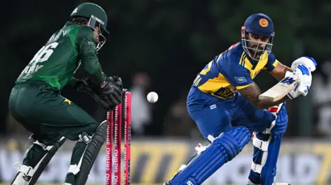 Pakistan wicketkeeper Khawaja Nafay and Sri Lanka batter Dhananjaya de Silva during the third T20 in Dambulla